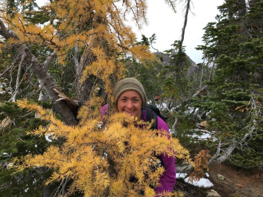 Woman behind a tree in the autumn