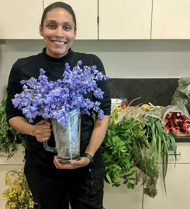 Chef Olivia holding a bouquet of flowers
